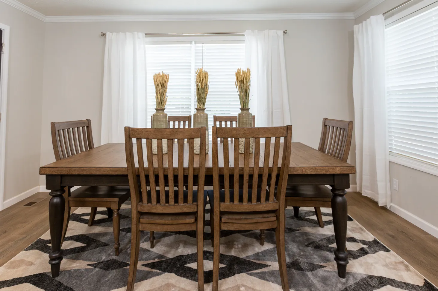 Dining room with large square table, two long benches, and four chairs
