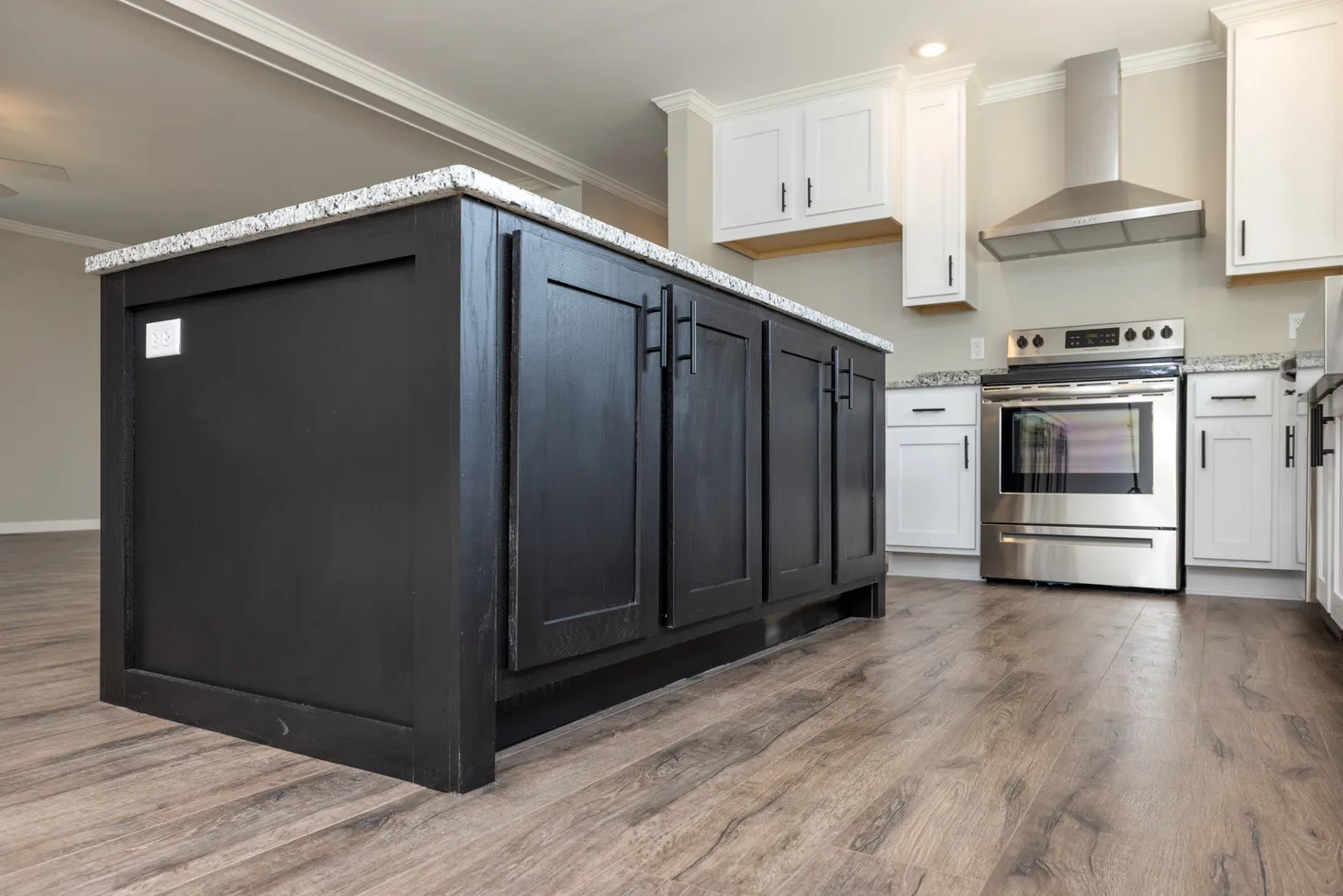 Low view of kitchen displaying black cabinets on the island.