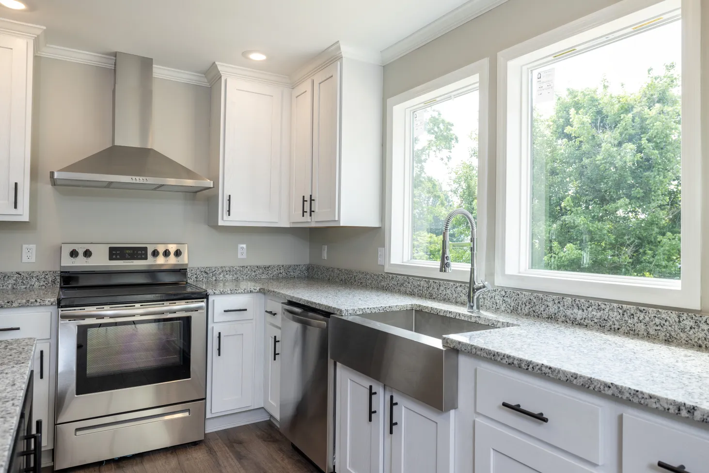Kitchen with farmhouse sink and black-and-white speckled countertop