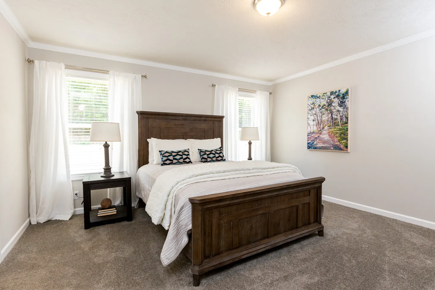 Large bedroom with full-sized bed and two side tables with lamps