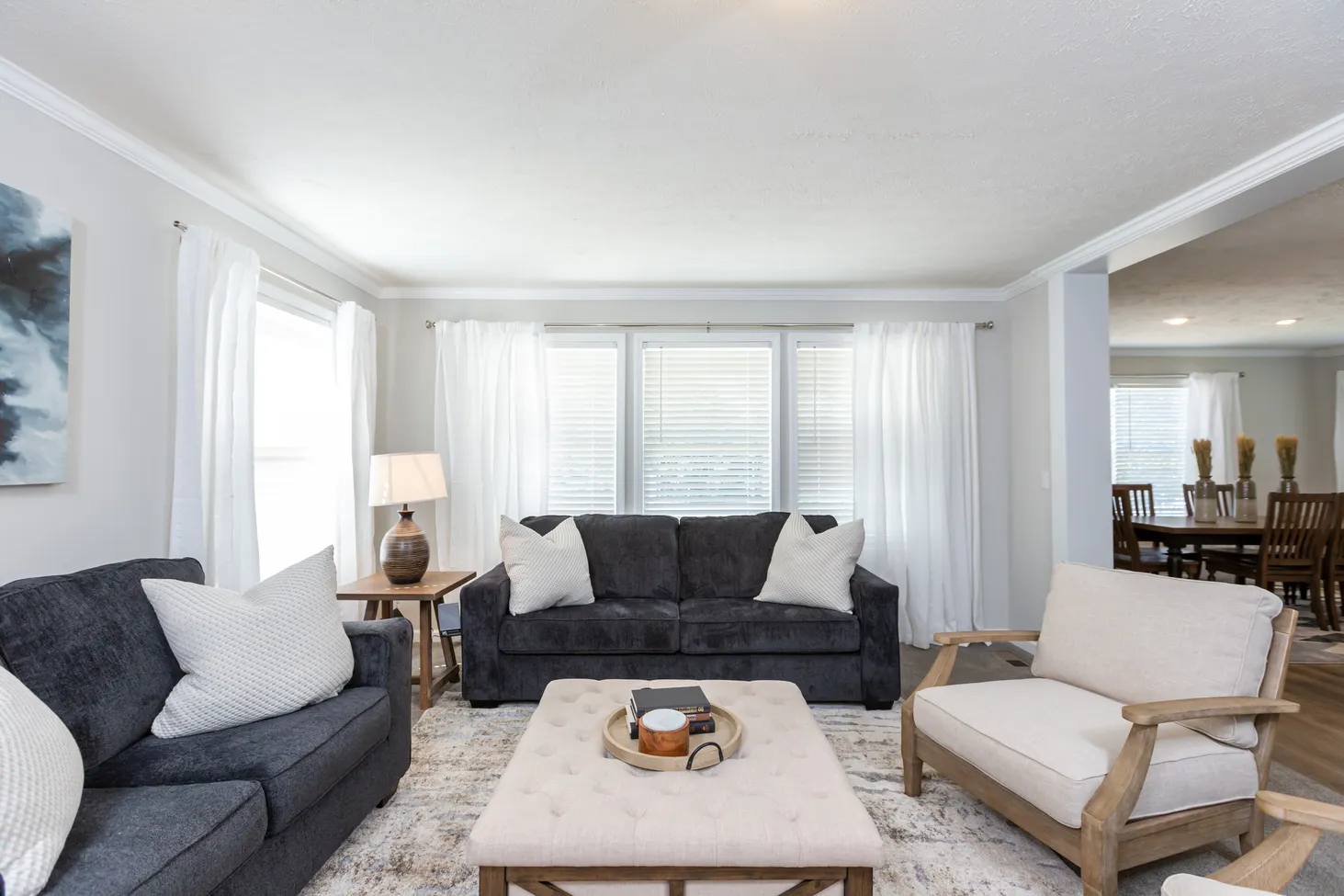 Partial view of large living room with loveseat, couch, and chair