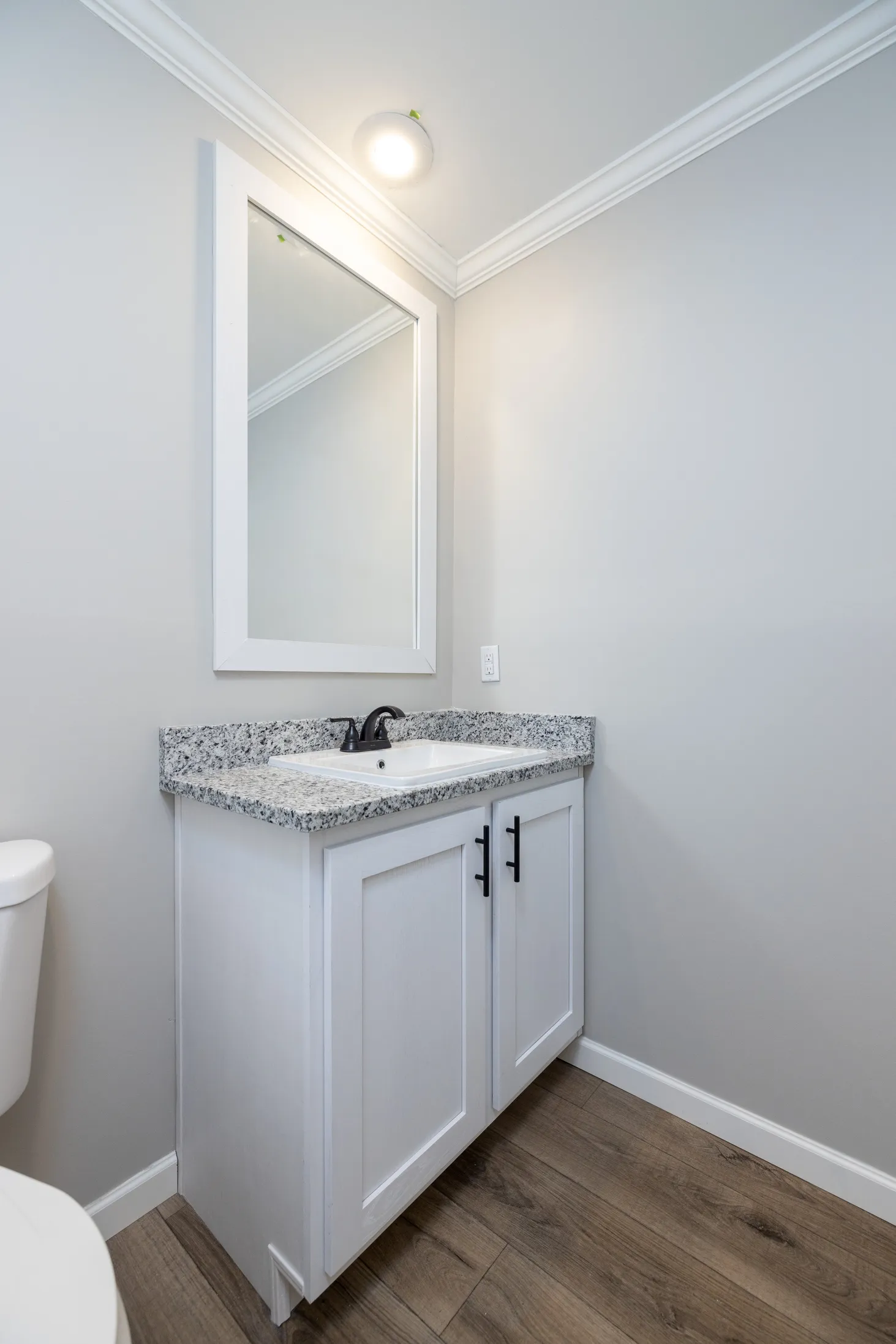 Bathroom sink with black and white speckled counter tops
