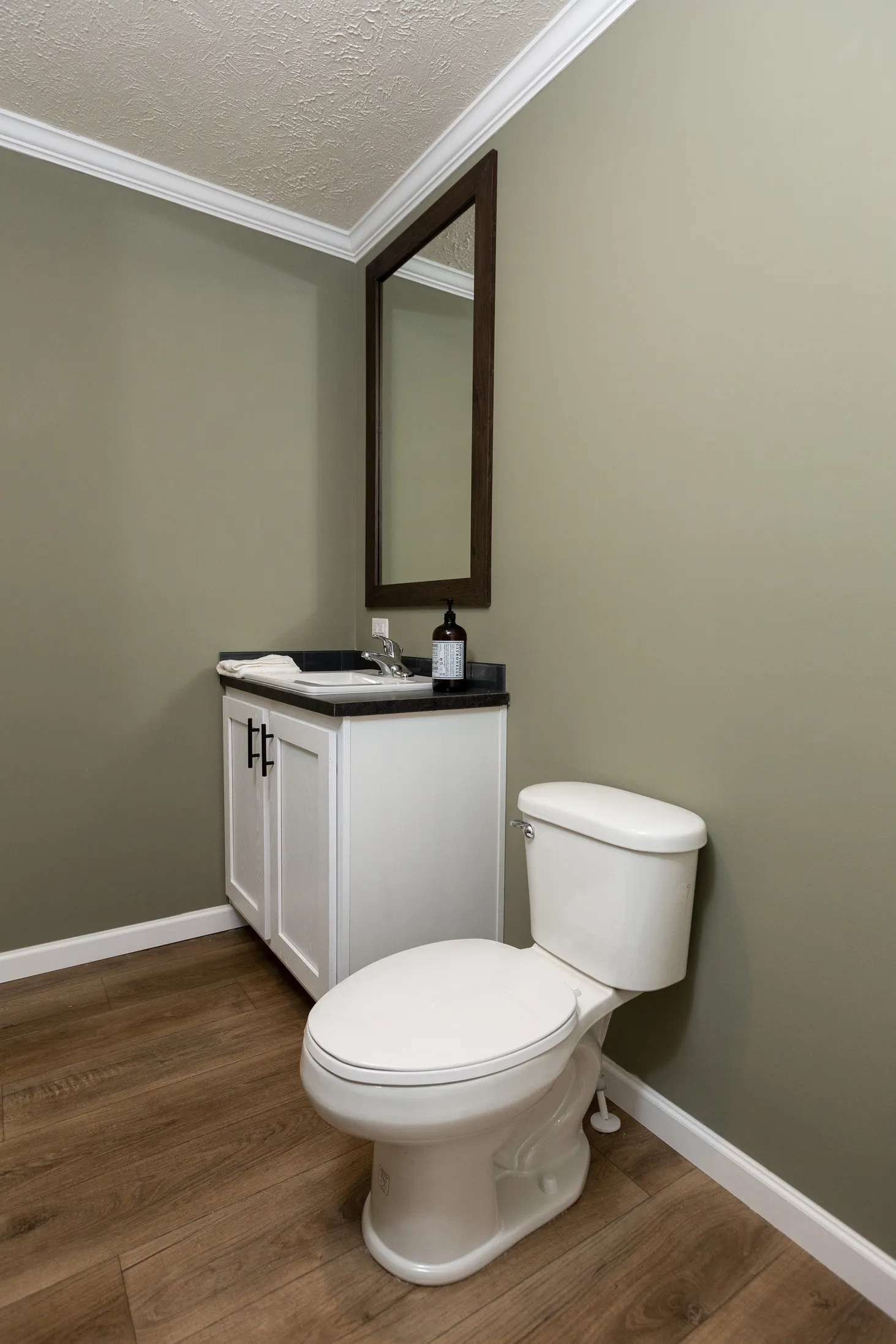 Small bathroom with green walls and single sink